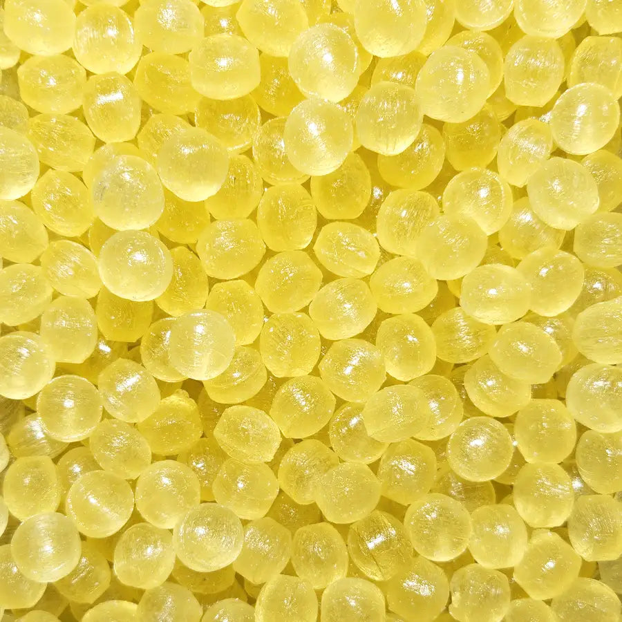 Close up of clear hard boiled candy with a sour lemon flavour called acid drops