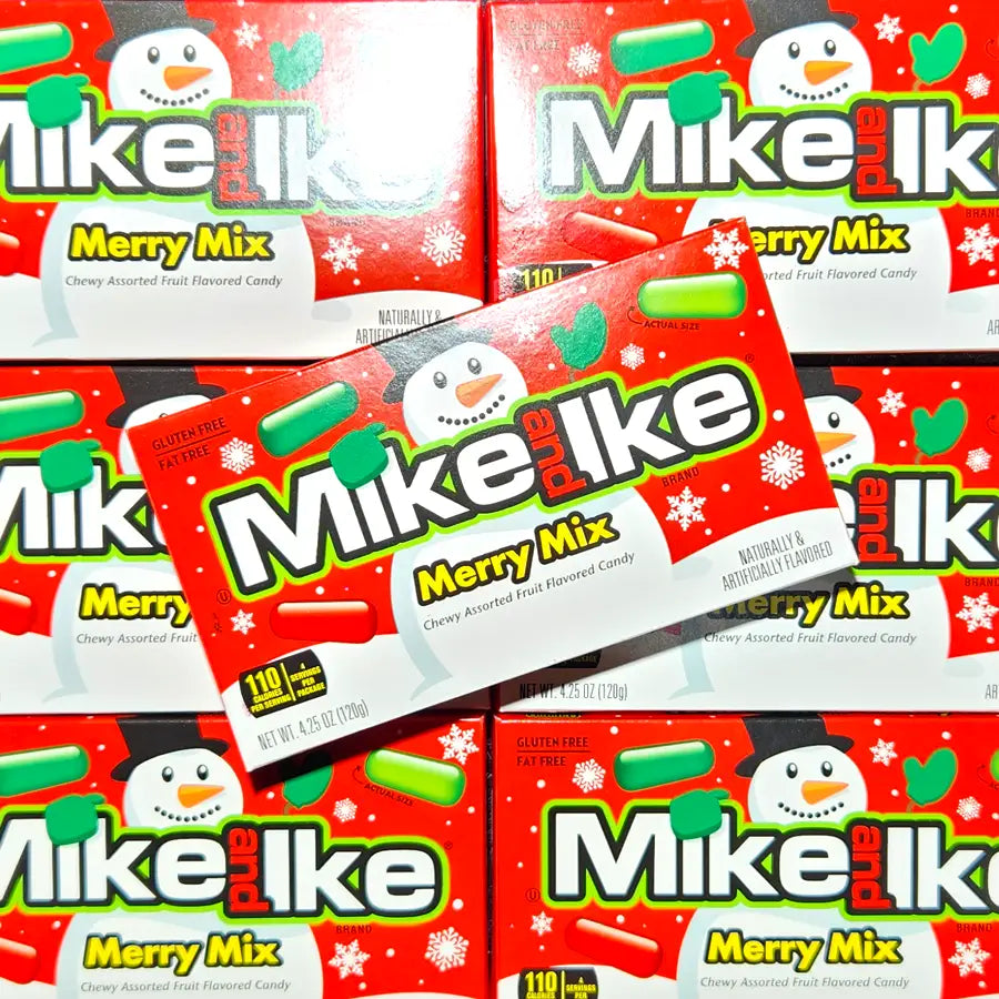 Multiple boxes of Mike and Ike Merry Mix candy with snowman design on a red background.
