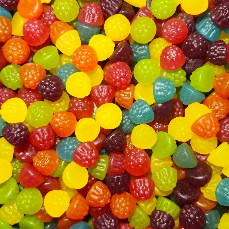 A variety of colorful gummy candies shaped like different berries, including what appears to be blackberries and raspberries.