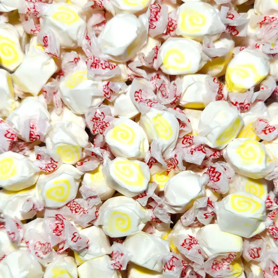 Assorted taffy candies with white, yellow, and red colors. Pina Colada Flavour