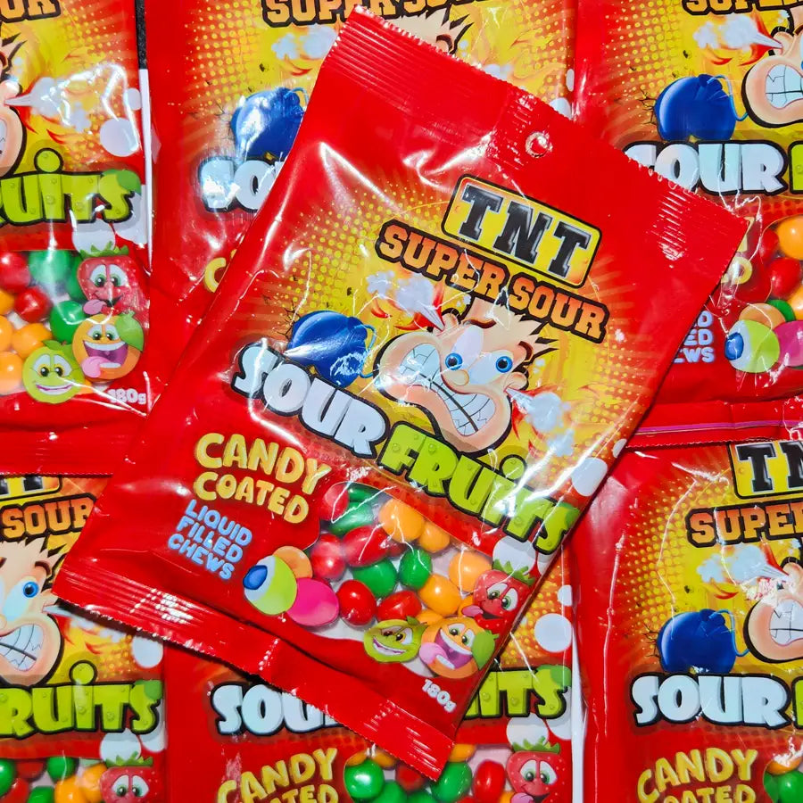 Red packet of TNT Super Sour Candy Coated Fruit with colorful graphics on a multicolored background