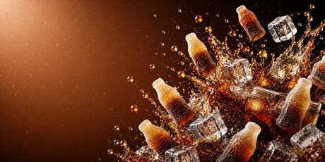 Bright cola themed banner featuring splashing cola, ice cubes, bubbles and cola bottle glasses on a rich brown gradient background