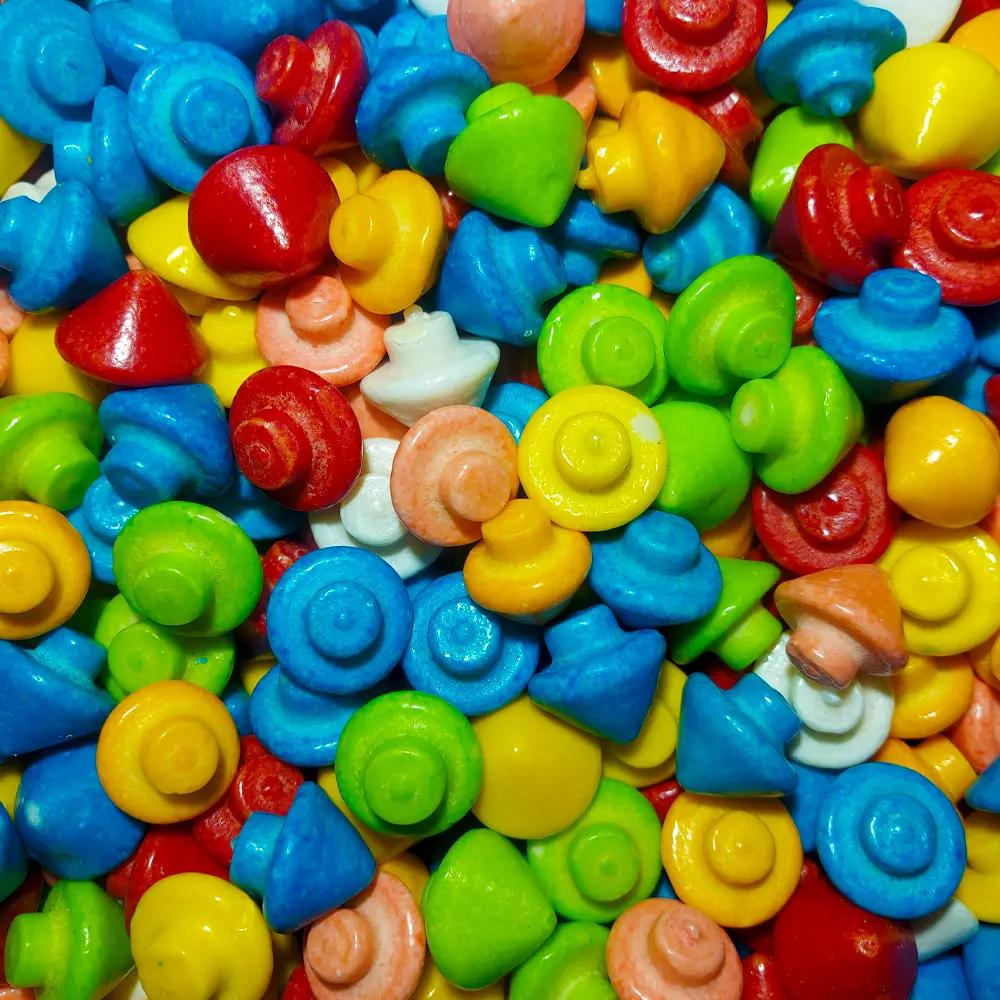 an assortment of colourful bubblegum spintops in a pile