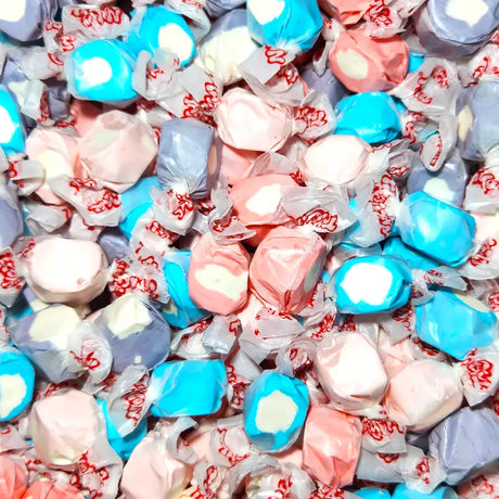 Assorted colorful taffy candies in clear wrappers with visible brand name. Berries and Cream Flavour