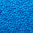 A close-up image of blue colored chocolate pebbles filling the entire frame.