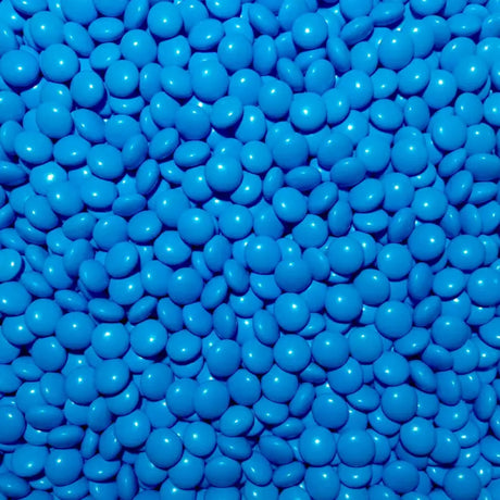 A close-up image of blue colored chocolate pebbles filling the entire frame.