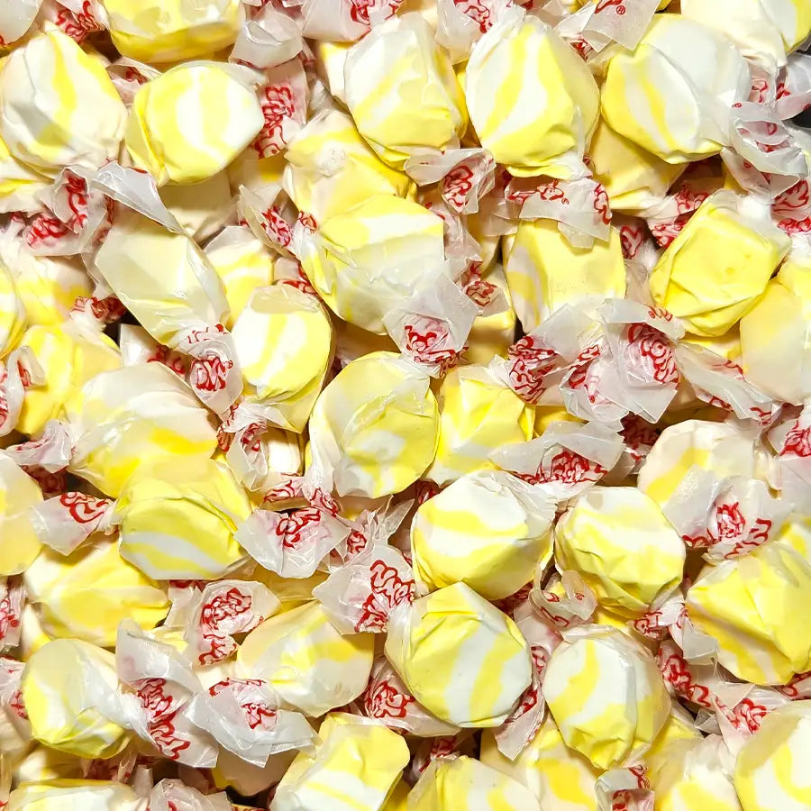 Yellow and white swirled candies in red and white wrappers. Popcorn and Butter falvoured