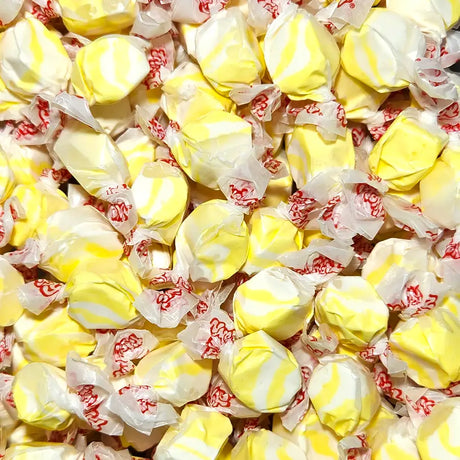 Yellow and white swirled candies in red and white wrappers. Popcorn and Butter falvoured