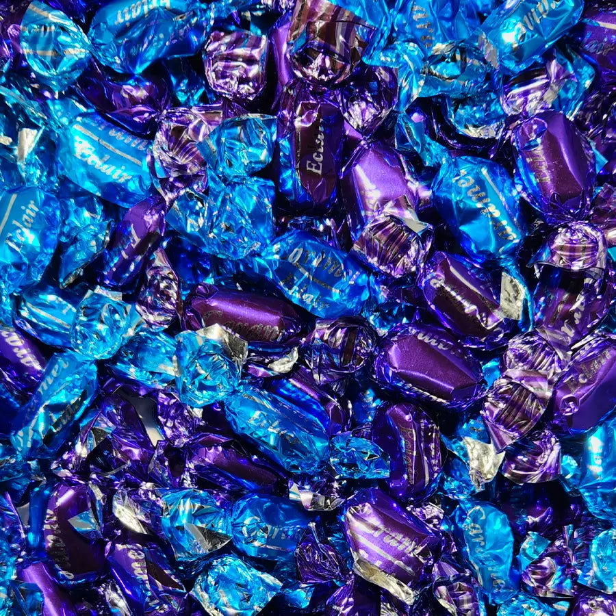 Close-up of blue and purple single wrapped candies with 'Eclair' branding