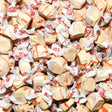 Close-up of wrapped taffy candies with visible brand name. Cherry Cola Flavour