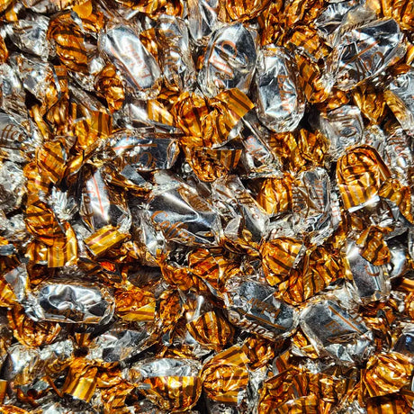 Close-up of gold and silver foil-wrapped candies with "coffee" flavour