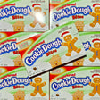 Multiple boxes of Gingerbread Cookie Dough Bites with a gingerbread man and house design on the packaging.