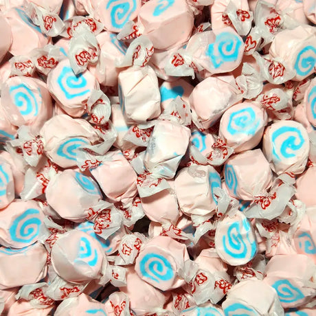 Pink taffy candies with blue swirls and red text in clear wrappers. Cotton Candy Flavour