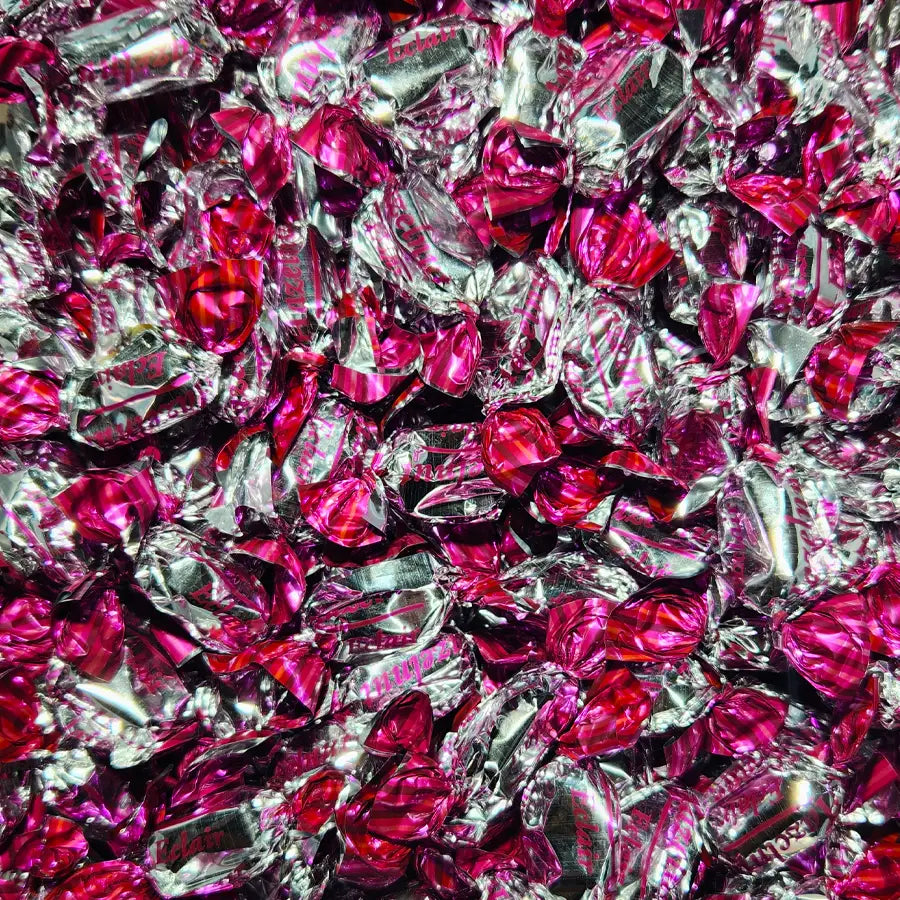 Close-up of pink and silver wrapped candies with "eclair" branding and hazelnut flavour