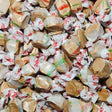 Close-up of taffy candies in clear wrappers with red text. Hot chocolate flavoured taffy