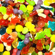 Assorted colorful gummy candies including bears, fish, and other shapes.