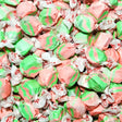 Close-up of pink and green striped candies with white wrappers. Taffy Town Kiwi Strawberry Flavoured Taffy