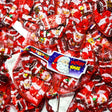 Red and white santa shaped foil wrapped chocolates in a red net bag