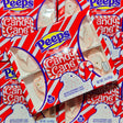 Multiple packages of Peeps Candy Cane flavor marshmallow chicks on a red background.