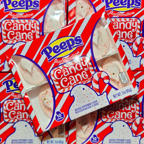 Multiple packages of Peeps Candy Cane flavor marshmallow chicks on a red background.