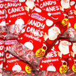 Red packets of Lolliland candy canes with Santa Claus illustrations on a red background.