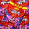 Multiple bags of Red Ripperz candy with Allen's branding on a red and purple background.