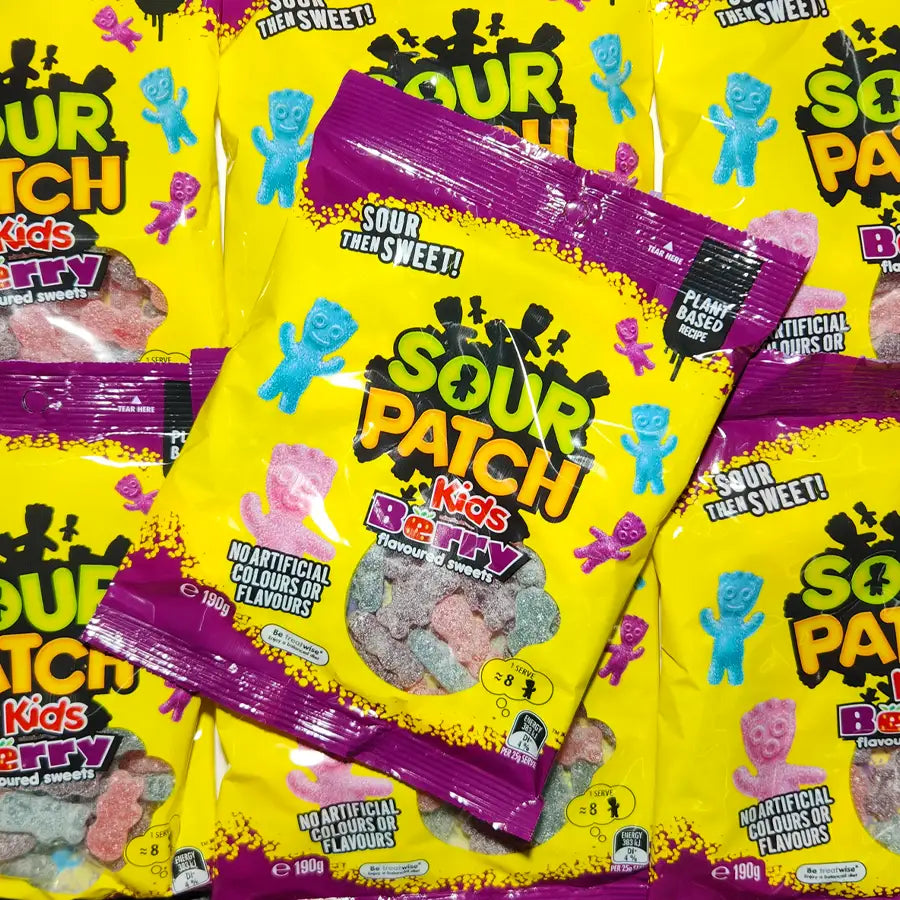 Multiple packages of Sour Patch Kids gummy candies with yellow and purple packaging.